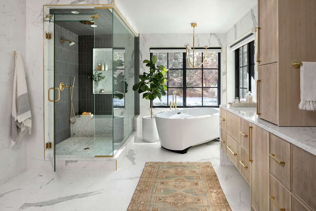 Primary suite bath with glass enclosed spa shower in remodeled Bow Mar home. By KGA Studio Architects